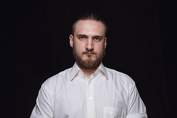 Image showing Close up portrait of young man isolated on black studio background