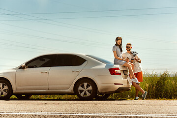 Image showing Young couple traveling on the car in sunny day