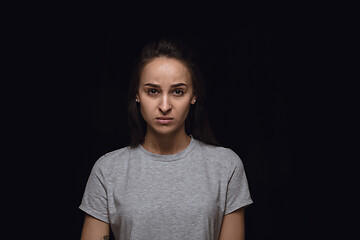 Image showing Close up portrait of young woman isolated on black studio background