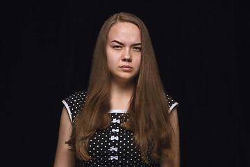 Image showing Close up portrait of young woman isolated on black studio background