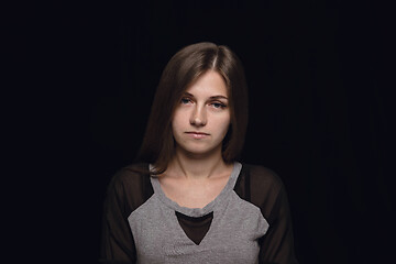 Image showing Close up portrait of young woman isolated on black studio background