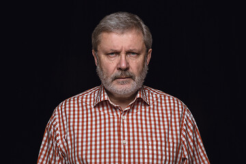 Image showing Close up portrait of senior man isolated on black studio background