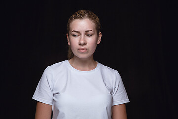 Image showing Close up portrait of young woman isolated on black studio background