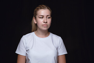 Image showing Close up portrait of young woman isolated on black studio background