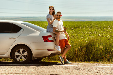 Image showing Young couple traveling on the car in sunny day