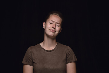 Image showing Close up portrait of young woman isolated on black studio background