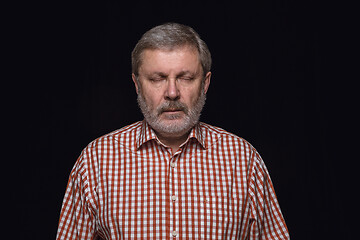 Image showing Close up portrait of senior man isolated on black studio background