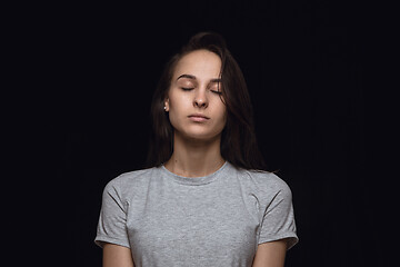 Image showing Close up portrait of young woman isolated on black studio background