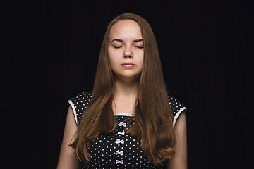 Image showing Close up portrait of young woman isolated on black studio background