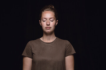 Image showing Close up portrait of young woman isolated on black studio background