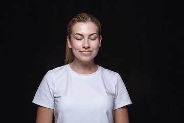 Image showing Close up portrait of young woman isolated on black studio background