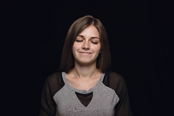 Image showing Close up portrait of young woman isolated on black studio background