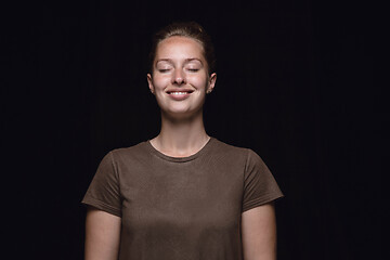 Image showing Close up portrait of young woman isolated on black studio background