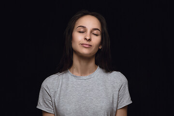 Image showing Close up portrait of young woman isolated on black studio background