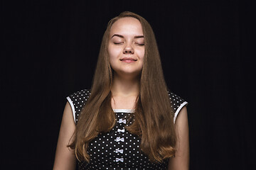 Image showing Close up portrait of young woman isolated on black studio background