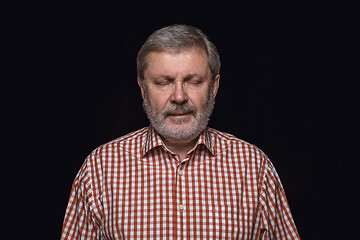Image showing Close up portrait of senior man isolated on black studio background