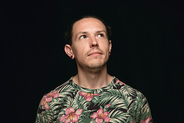 Image showing Close up portrait of young man isolated on black studio background