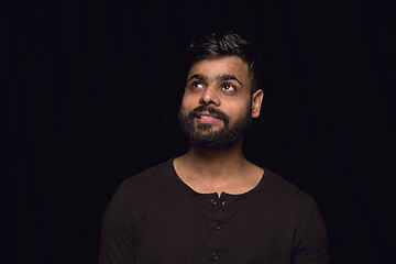 Image showing Close up portrait of young man isolated on black studio background