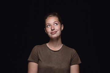 Image showing Close up portrait of young woman isolated on black studio background