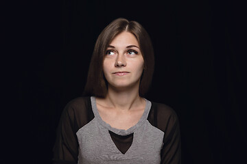 Image showing Close up portrait of young woman isolated on black studio background