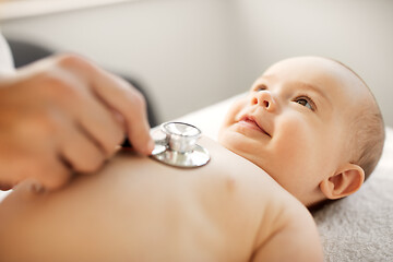 Image showing doctor with stethoscope listening to baby patient