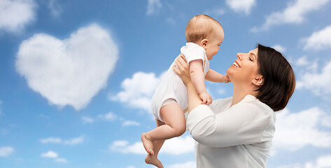 Image showing happy middle-aged mother with little baby daughter