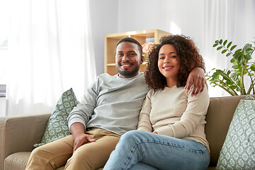 Image showing happy african american couple hugging at home