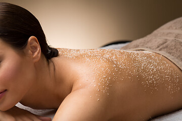 Image showing close up of woman with sea salt on skin at spa