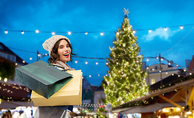 Image showing woman with shopping bags at christmas market