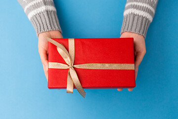 Image showing hands holding red christmas gift box