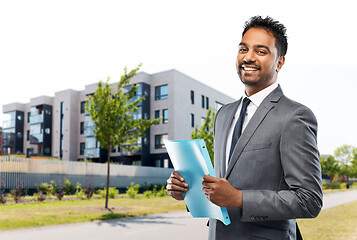 Image showing indian man realtor with folder on city street