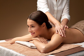 Image showing woman lying and having back massage at spa