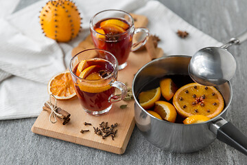 Image showing pot with hot mulled wine, orange slices and spices