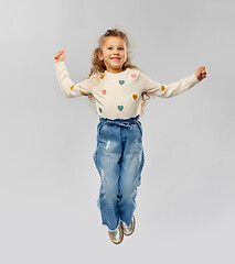 Image showing smiling little girl jumping