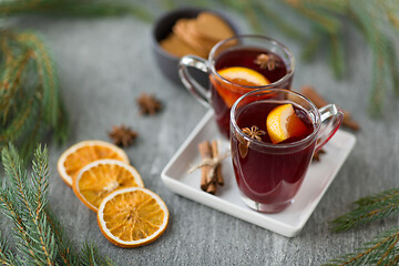 Image showing mulled wine, orange slices, gingerbread and spices