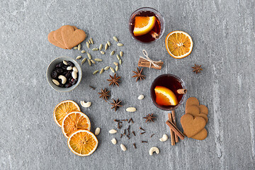 Image showing hot mulled wine, orange slices, raisins and spices