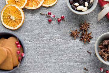 Image showing hot mulled wine, orange slices, raisins and spices