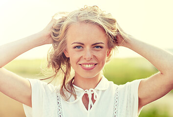 Image showing close up of happy young woman in white outdoors