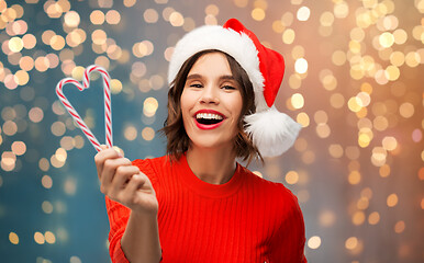 Image showing happy young woman in santa hat on christmas