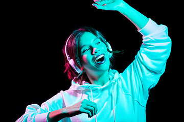 Image showing woman in headphones listening to music and dancing