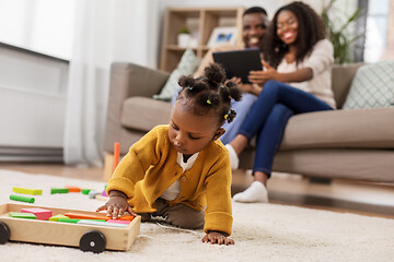 Image showing african baby girl playing with toy blocks at home