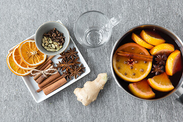 Image showing pot with hot mulled wine, orange slices and spices