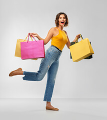 Image showing happy smiling young woman with shopping bags