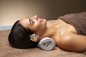 Image showing young woman lying at spa or massage parlor