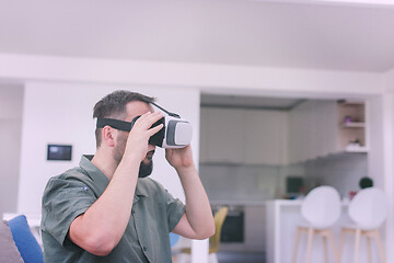 Image showing man with beard trying vr glasses