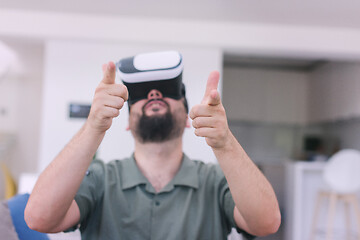 Image showing man with beard trying vr glasses