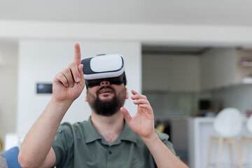 Image showing man with beard trying vr glasses