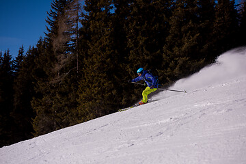 Image showing Skier having fun while running downhill