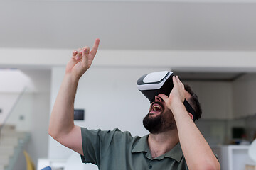 Image showing man with beard trying vr glasses