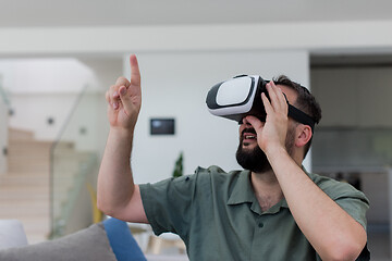 Image showing man with beard trying vr glasses